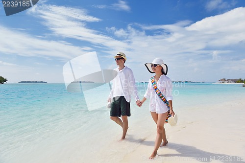 Image of happy young couple have fun on beach