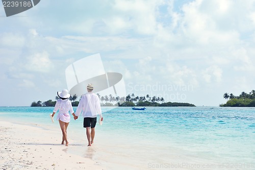 Image of happy young couple have fun on beach
