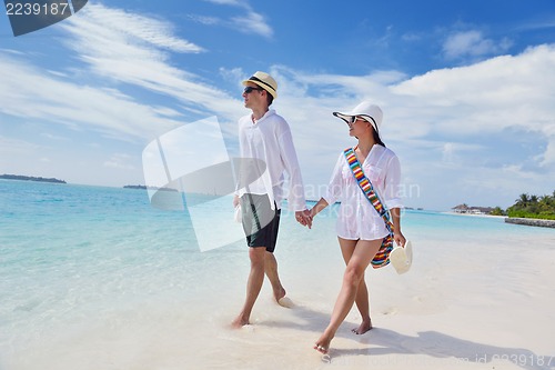 Image of happy young couple have fun on beach