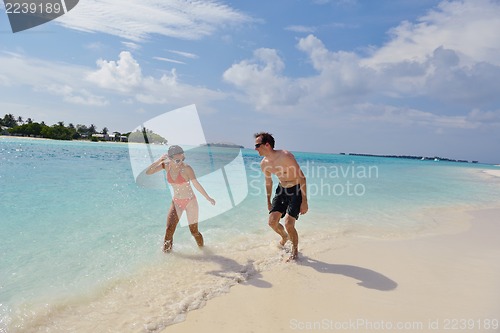 Image of happy young couple have fun on beach