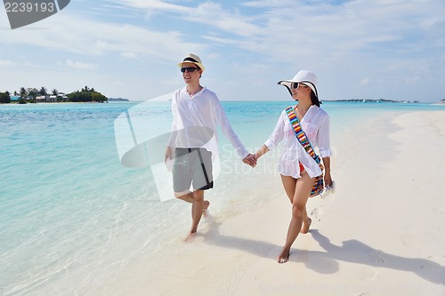 Image of happy young couple have fun on beach