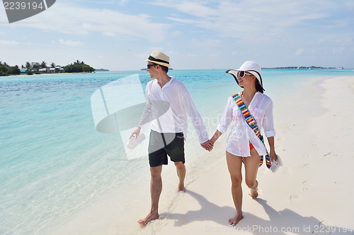 Image of happy young couple have fun on beach