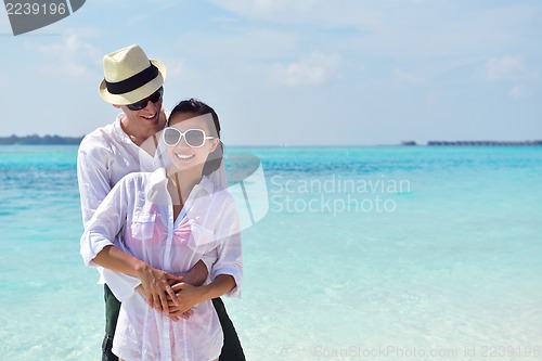 Image of happy young couple have fun on beach