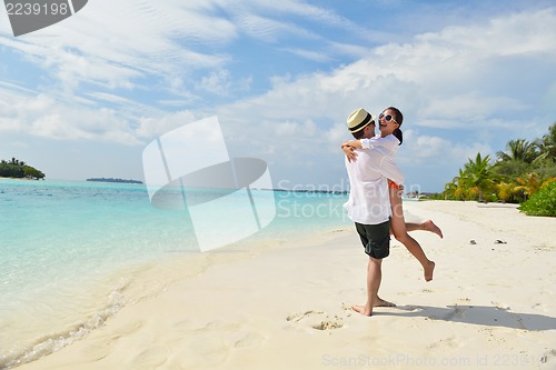 Image of happy young couple have fun on beach