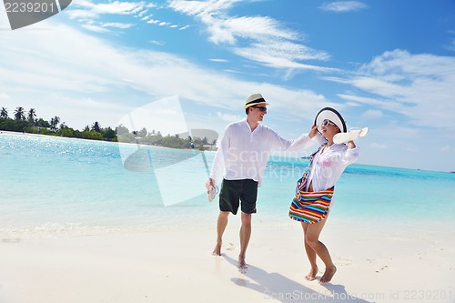 Image of happy young couple have fun on beach