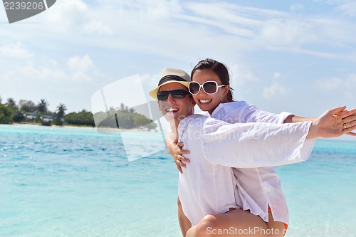 Image of happy young couple have fun on beach