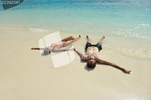 Image of happy young couple have fun on beach