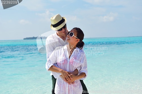 Image of happy young couple have fun on beach