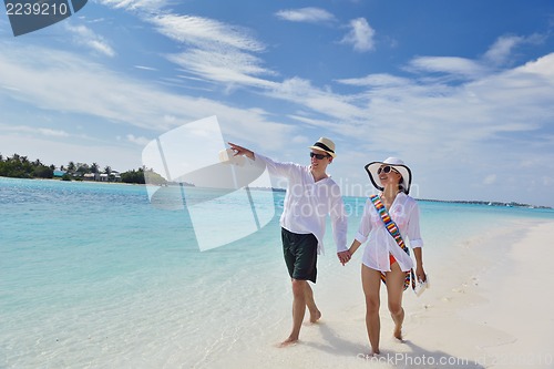 Image of happy young couple have fun on beach