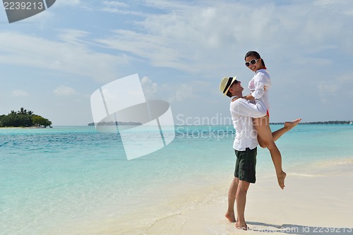 Image of happy young couple have fun on beach