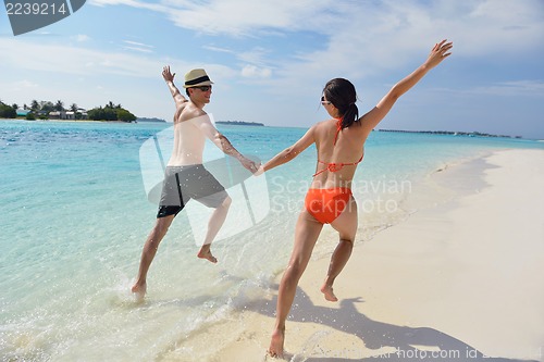 Image of happy young couple have fun on beach
