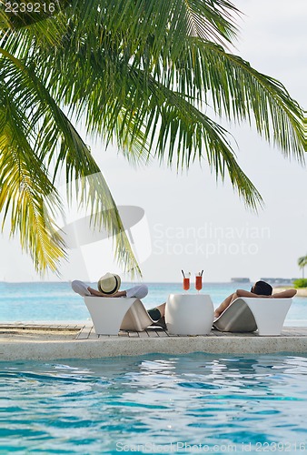 Image of happy young couple have fun on beach