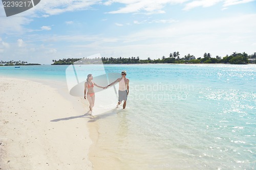 Image of happy young couple have fun on beach