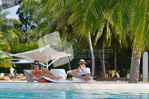Image of happy young couple have fun on beach
