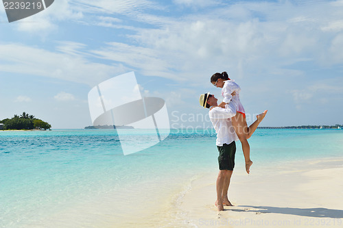 Image of happy young couple have fun on beach