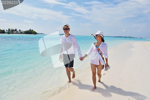 Image of happy young couple have fun on beach