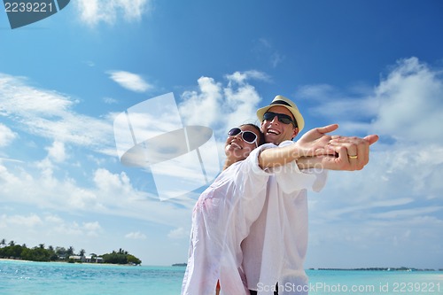 Image of happy young couple have fun on beach