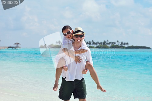 Image of happy young couple have fun on beach