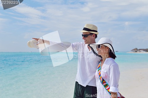 Image of happy young couple have fun on beach