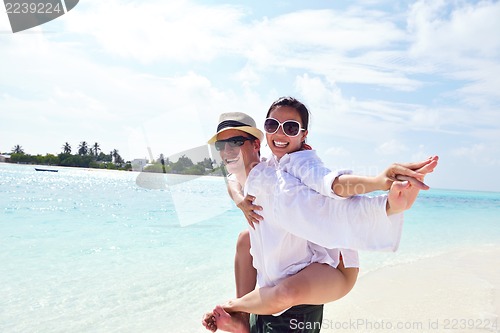 Image of happy young couple have fun on beach