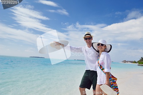 Image of happy young couple have fun on beach