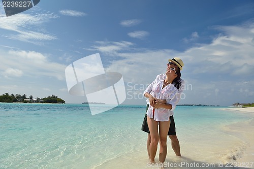 Image of happy young couple have fun on beach