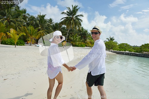 Image of happy young couple have fun on beach
