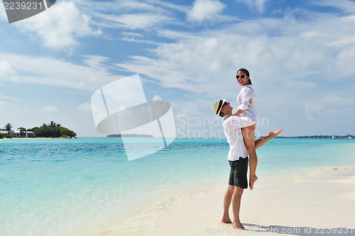 Image of happy young couple have fun on beach