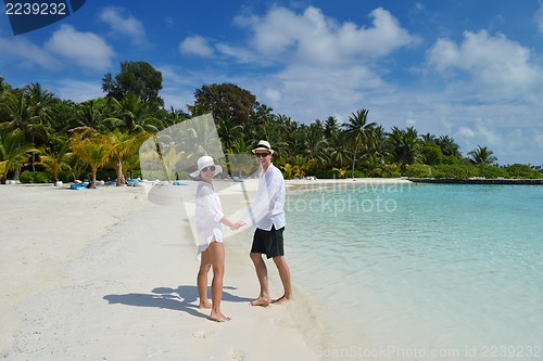 Image of happy young couple have fun on beach