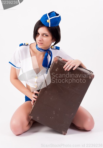 Image of Beautiful air stewardess with suitcase