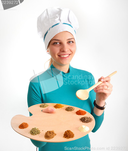 Image of Spices and herbs on the palette and cook gir