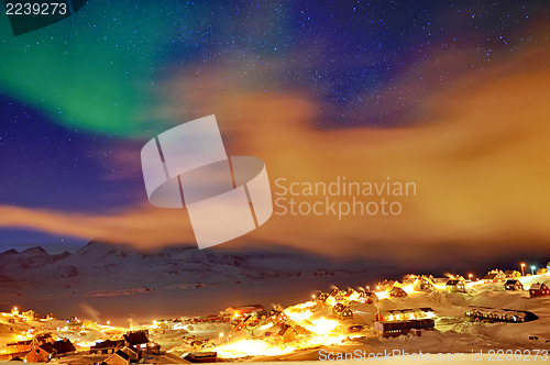 Image of Tasiilaq in mist and northern lights