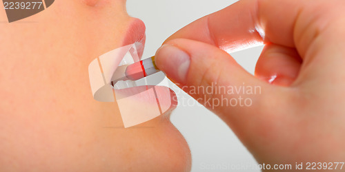 Image of Woman taking pills