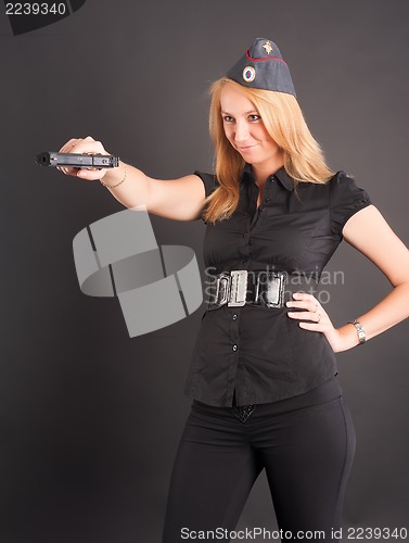 Image of pretty girl holding a gun