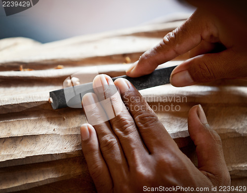 Image of Hands woodcarver with the tool close-up