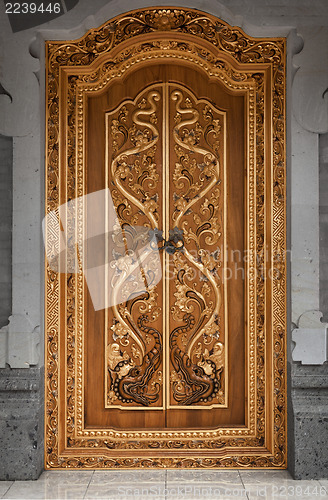 Image of Wooden door of an old temple with carvings. Indonesia, Bali