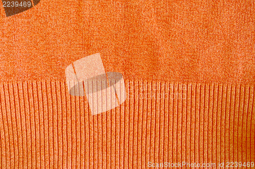 Image of orange knitted wool sweater closeup background 