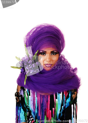 Image of Woman with purple twill and flowers.