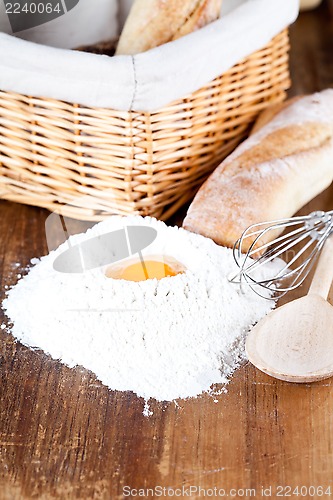 Image of  bread, flour, eggs and kitchen utensil 