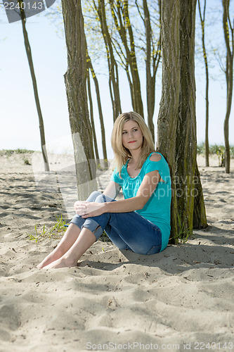 Image of Woman sitting on beach