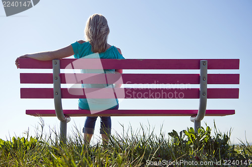 Image of Woman sitting on bench