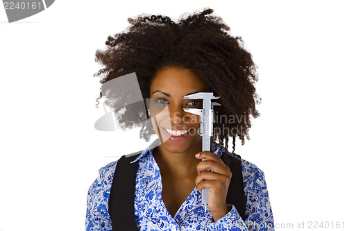 Image of Attractive african woman holding caliper