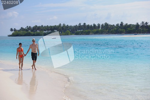 Image of happy young couple have fun on beach