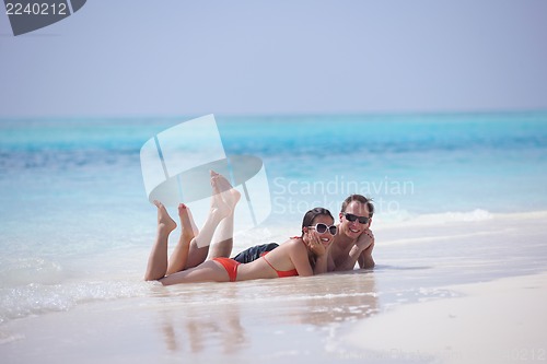 Image of happy young couple have fun on beach