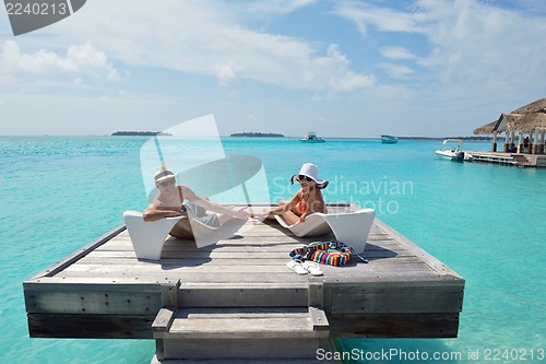 Image of happy young couple have fun on beach