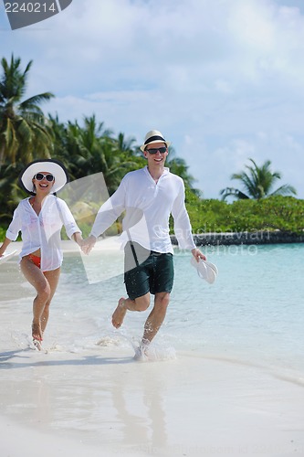 Image of happy young couple have fun on beach