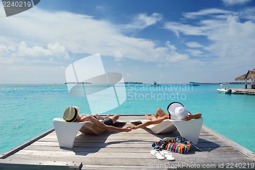 Image of happy young couple have fun on beach