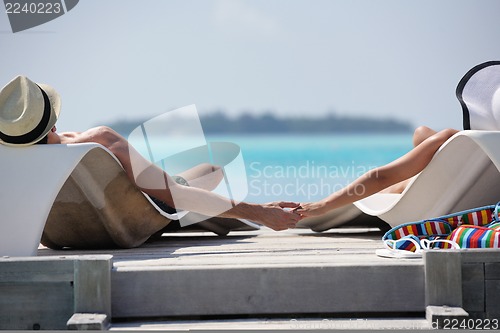 Image of happy young couple have fun on beach