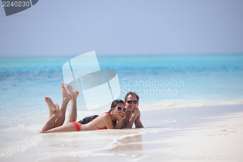 Image of happy young couple have fun on beach
