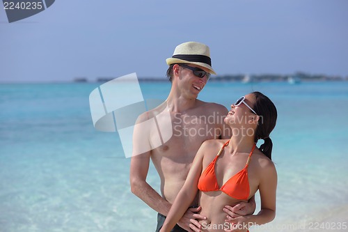 Image of happy young couple have fun on beach